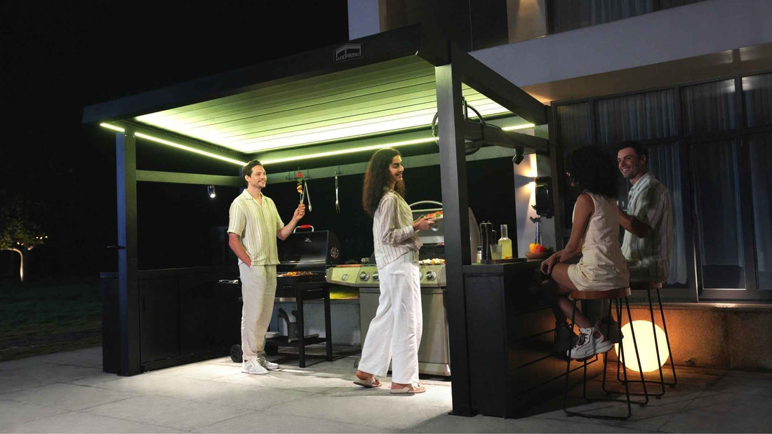 A modern outdoor gathering with warm lighting at the bar and a chat among four people