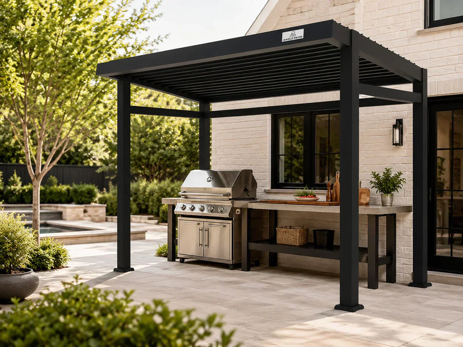 Covered backyard grill area under an open-sided aluminum louvered pergola