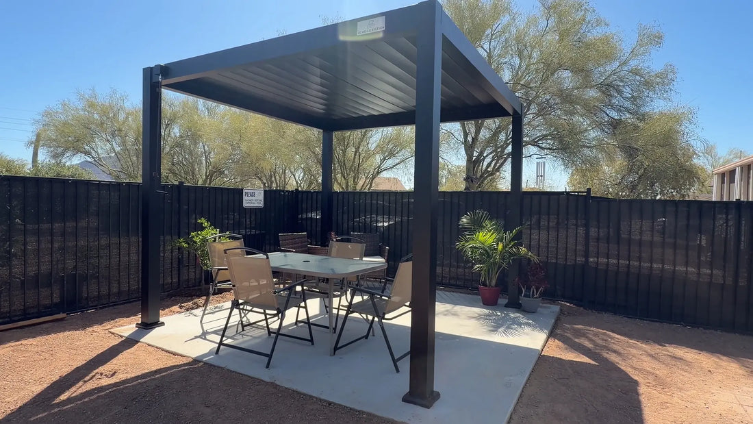 Aluminum louvered pergola installed on a backyard patio with visible post bases and patio surface support area.